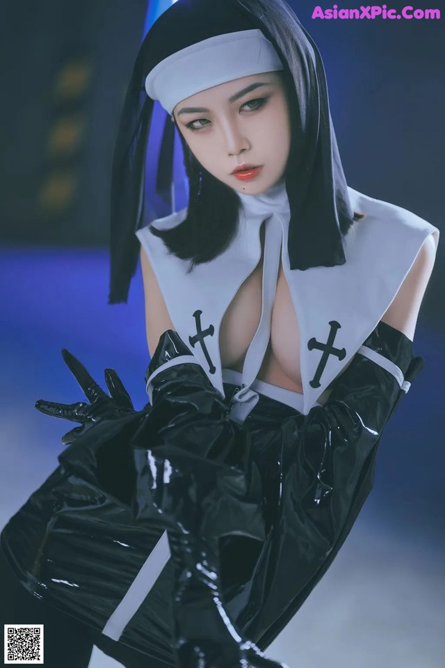 A woman dressed as a nun in a black and white outfit.