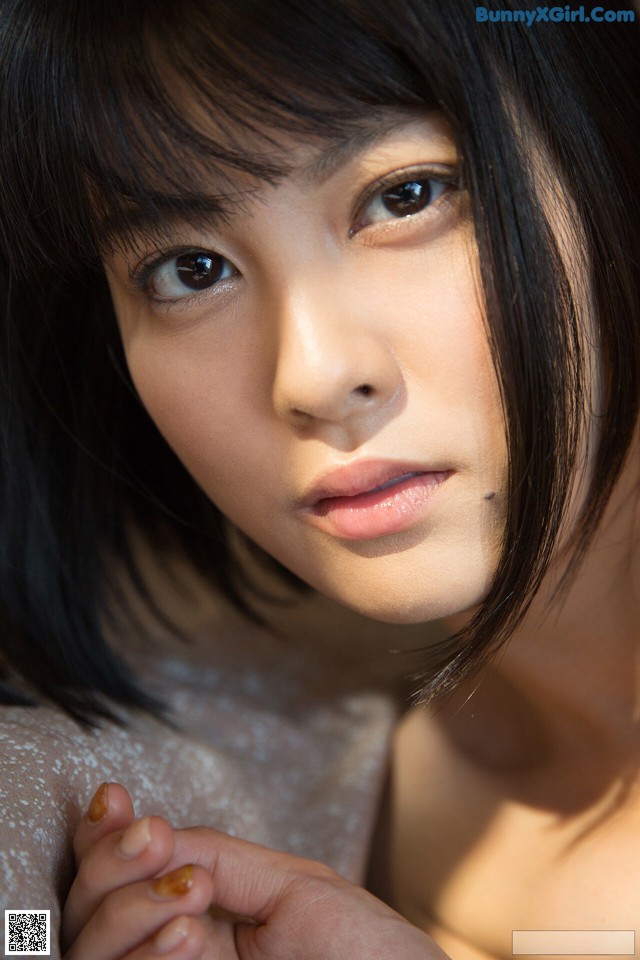 A close up of a woman with long black hair.